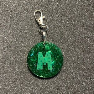 Green circle “M” keychain $10